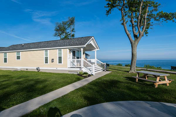 Side view of cottage with lake in the background at The Lodge at Geneva-on-the-lake